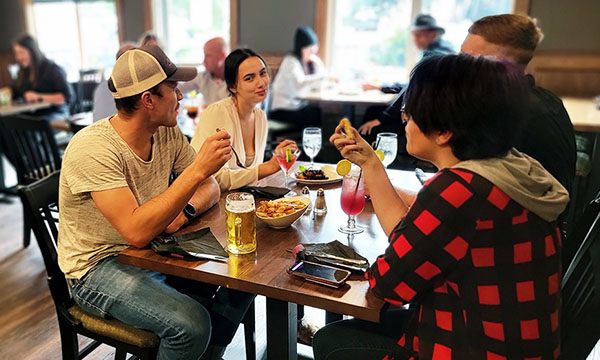 A group of friends enjoying some drinks and appetizers in the Ram's Head Pub.
